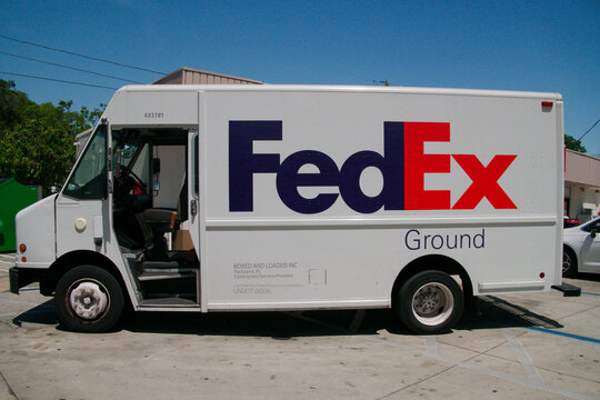 Editorial Use Only March 27, 2025. St. Petersburg, FL, USA. Sunny day Wide Side view image shows a FedEx Ground delivery truck. FedEx Ground is a division of FedEx that specializes in ground transport