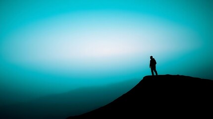 Silhouette of person on mountaintop, tranquil sunrise