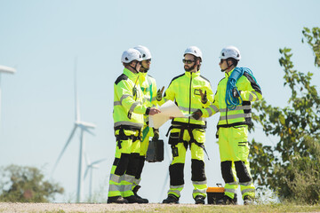 Fototapeta premium Team of electrical engineer is perform the inspection and maintenance of electric generating windmill turbine.