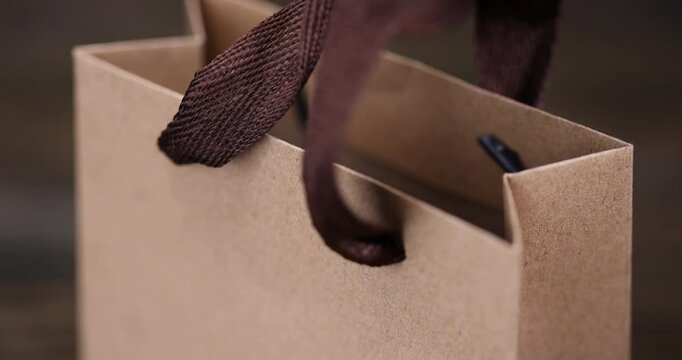 brown paper gift wrapping bag, made from recycled paper, small gift bag with brown satin ribbon handles