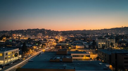Fototapeta premium Night cityscape, illuminated buildings, hills, twilight sky.