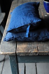 Cozy Dark Blue Cushions on Rustic Wooden Table Background