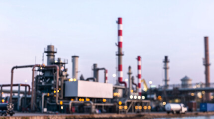 Blurred of industrial complex or oil distillation tower with smokestacks at dusk