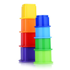 A toy tower made of colored plastic cups isolated on a white background. A children's pyramid made of sand molds.