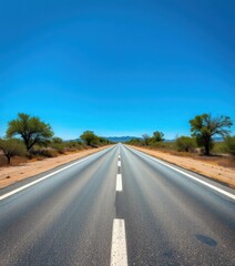 Fototapeta premium Endless asphalt road vanishing into a deep blue sky, expanse, vast
