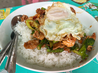 thai food fried pork with egg, fried egg and rice.
