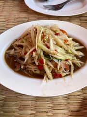thai spicy papaya salad on dish