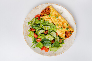 omelet with vegetables on the white plate