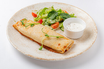 omelet with vegetables on the white plate