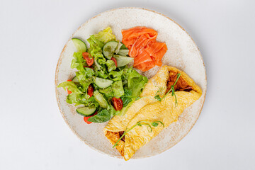omelet with vegetables on the white plate