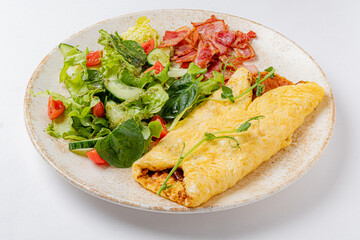 omelet with vegetables on the white plate