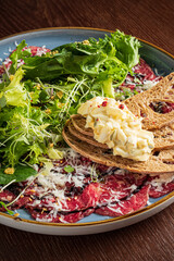 carpaccio with bread and salad