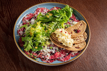 carpaccio with bread and salad