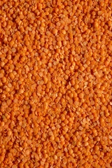 Red lentils background, full frame.
