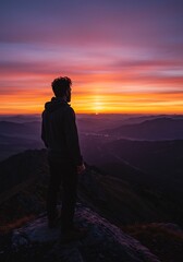 Obraz premium Silhouette Man Watching Vibrant Sunrise Mountains. AI Generated