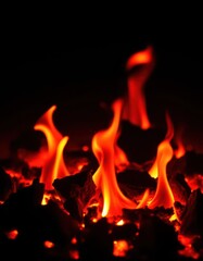 Fototapeta premium Tiny embers glowing intensely against a dark background, embers, macro, heat