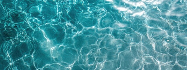 Fototapeta premium Clear turquoise water ripples under sunlight creating a tranquil atmosphere by the shore
