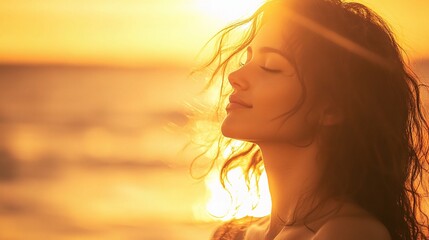 Woman Enjoying a Warm Breeze Under the Golden Sunlight at Sunset