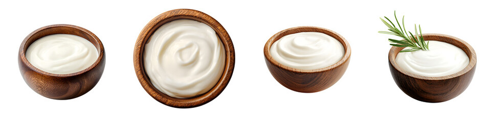 Assortment of natural healthy dairy products such as sour cream yogurt and other creamy delicacies served in simple wooden bowls with a fresh green herb garnish