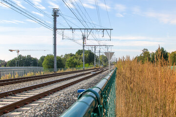 Safety fencing on railway tracks made of metal mesh. Selected focus