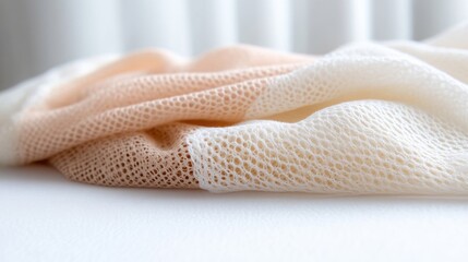 Soft, textured knitted fabric in peach and cream