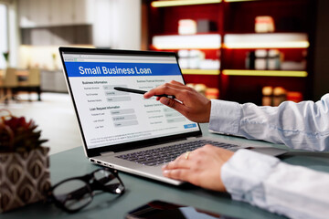 Person Hand Over Small Business Loan Application