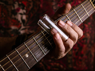 Male musician hand play Vintage Resonator acoustic dobro blues slide guitar.