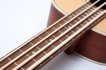 Fototapeta premium Four-string bass ukulele with wooden body and built-in tuner and pickup.