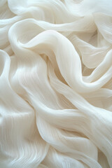 Fototapeta premium Flowing white fabric with gentle waves, ideal for backgrounds and fashion, conveying elegance and lightness