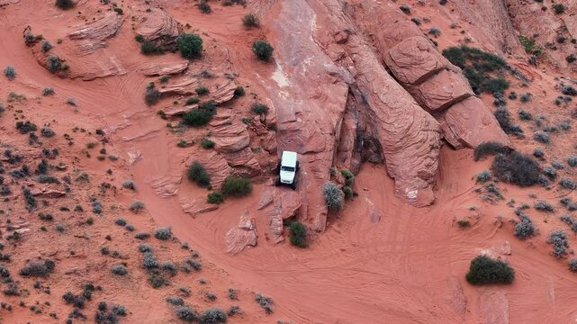 Aerial Sand Hollow Utah desert white off road. Southern desert Sand Hollow. Red sandstone, dirt, sand trails, rocky cliffs and ledges. Nature erosion into canyons. Outdoor extreme 4x4 recreation.