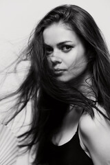 Intense expression of a young woman with flowing hair, gazing directly at the viewer. Artistic...