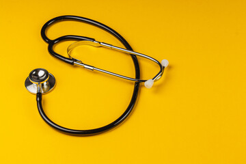 Stethoscope on vibrant yellow background