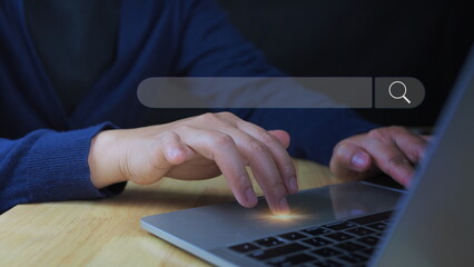 Businessman using computer laptop with search bar icon for browsing information network and SEO or...