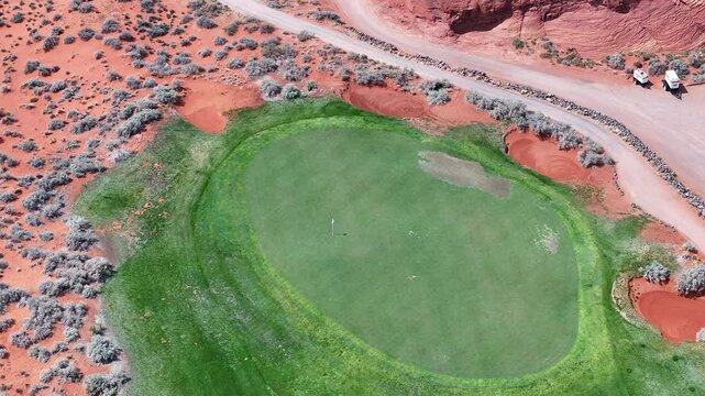 Aerial Sand Hollow Utah desert golf course green. Southwestern desert St George. Fairway, green, tee golfing sport and recreation. Geological landscape  erosion, beautiful red rock mountain valley.