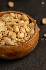 fried yellow peanuts with a little salt on the table