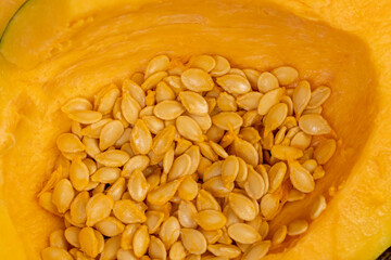 freshly cut orange pumpkin with cooking seeds