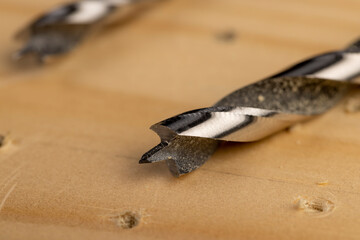 pine board that is drilled with steel drills