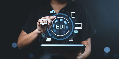 Businesswoman using EDI technology on a tablet in a digital environment.
