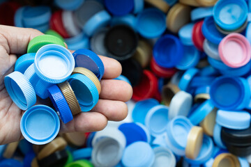 Close up hand hold a plastic bottles for recycling to conserve the environment, recycling, reuse, garbage disposal, save the world concept