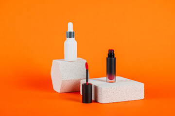 Mockup of black blank thin tube - mascara, lip gloss, gel, eyeliner, oil, etc. Cosmetic package with stylish props on orange background.