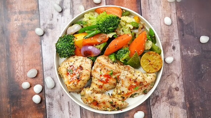 Roasted Chicken on plate with mix vegetable, Garlic Chicken on plate on wooden table
