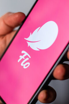 Kaliningrad, Russia 14.01.25 - Woman holding smartphone with FLO application logo on screen. Controlling woman period, ovulation, pregnancy. Female health concept.
