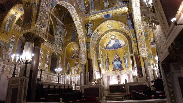 Walking towards dome decorated with gold and detailed mosaics in the Palatine Chapel inside the Norman Palace in Palermo, Italy
