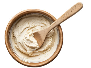 Wooden spatula stirring creamy batter in a mixing bowl