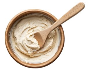 Wooden spatula stirring creamy batter in a mixing bowl