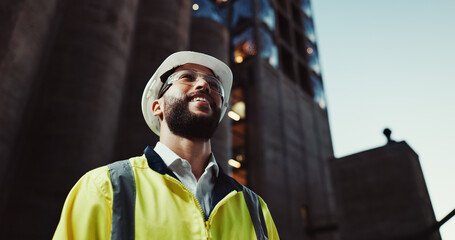 Man, engineer and thinking in city with smile for urban expansion, construction and low angle by...