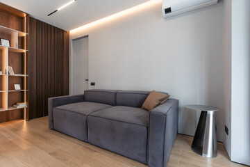 Business room interior with pc computer on desk, shelf with business documents, hardwood floor. Copy space wooden wall, 3D rendering