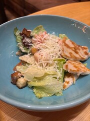 diet salad with herbs and chicken on a plate in a restaurant