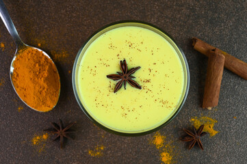 Turmeric milk served in a glass cup.
