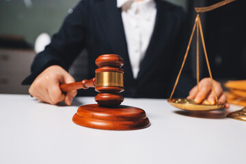Judge gavel with Justice lawyers having team meeting at law firm background. Concepts of Law and...